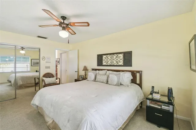 a bathroom with a granite countertop toilet sink and mirror