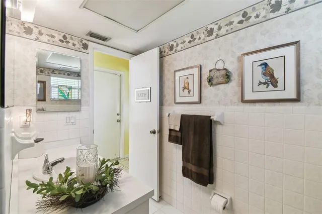 a dining room with furniture water view and a floor to ceiling window