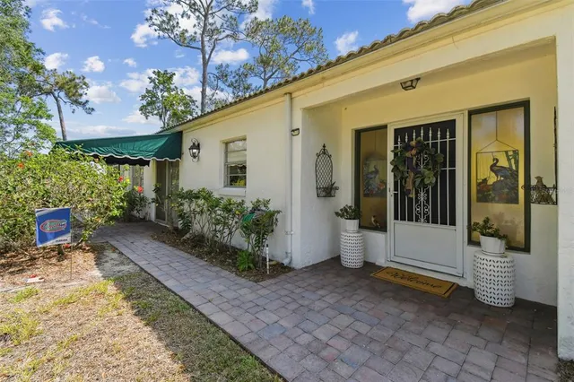 an aerial view of a house with a yard and balcony