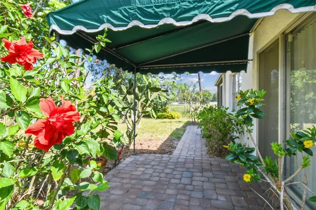 an aerial view of residential house with outdoor space and trees all around
