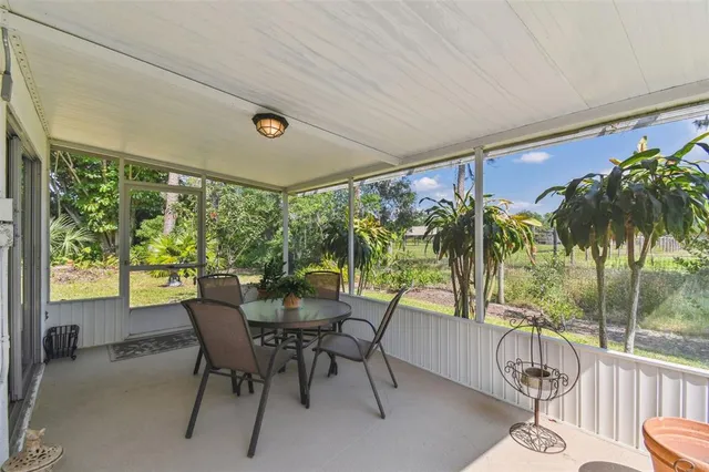 a dining room with furniture window and outside view