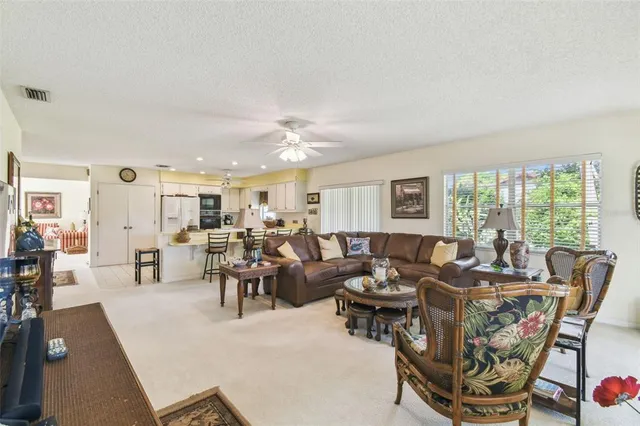 a living room with furniture dining table and a large window