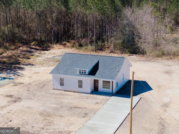 a aerial view of a house with a yard