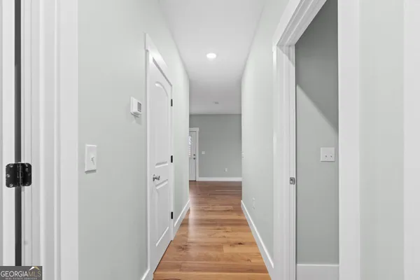 a view of a hallway with white walls