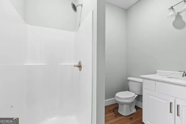 a white toilet sitting next to a bathroom sink