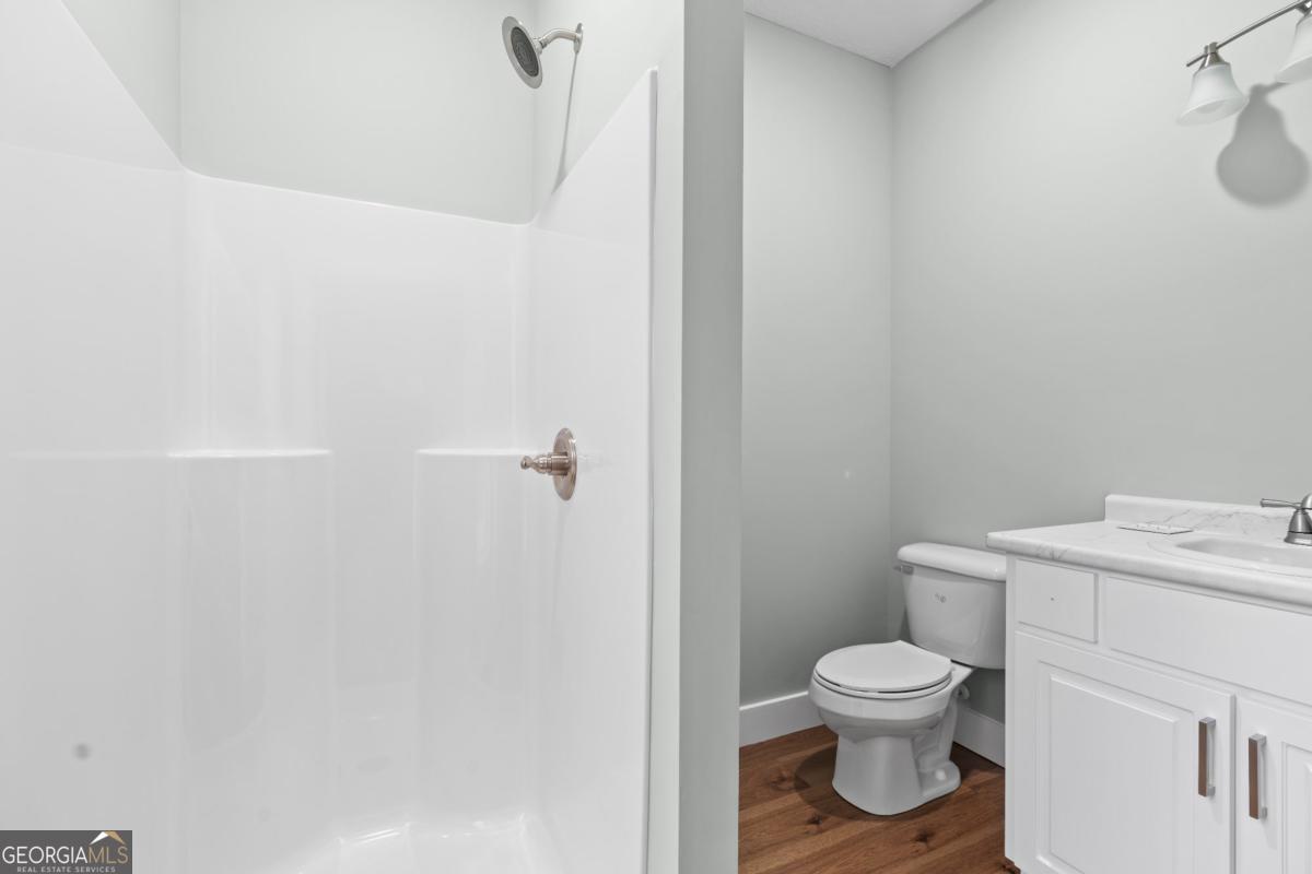 596 Beach Road Baxley, GA 31513 - Photo 14 of 17 a white toilet sitting next to a bathroom sink