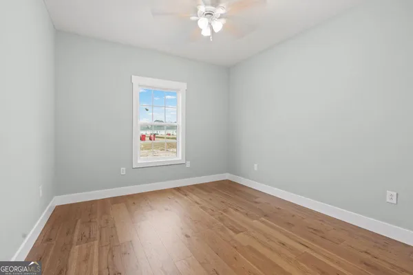 wooden floor in an empty room with a window
