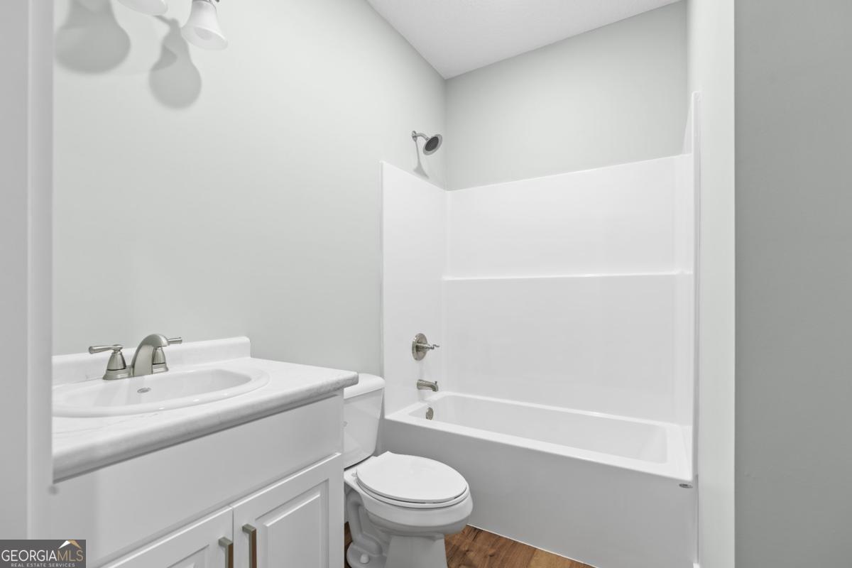 596 Beach Road Baxley, GA 31513 - Photo 17 of 17 a bathroom with a sink toilet and shower