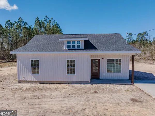 a house that has a tree in front of it