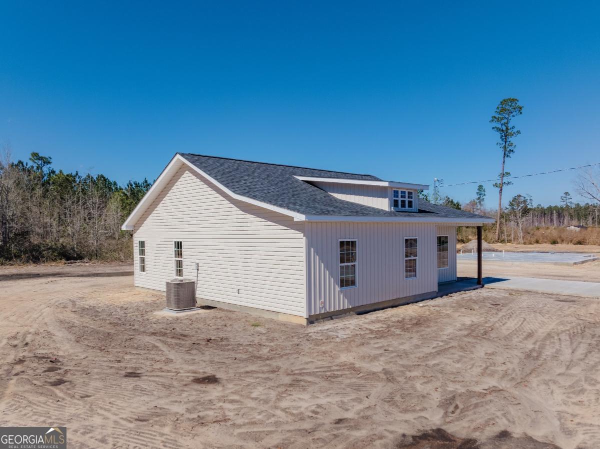 596 Beach Road Baxley, GA 31513 - Photo 3 of 17 a view of a white house with a yard