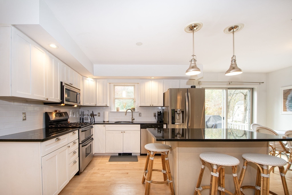 21 Union Street Marshfield, MA 02050 - Photo 7 of 31 a kitchen with stainless steel appliances kitchen island granite countertop a sink and cabinets