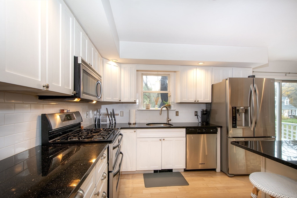 21 Union Street Marshfield, MA 02050 - Photo 8 of 31 a kitchen with a sink stainless steel appliances and cabinets