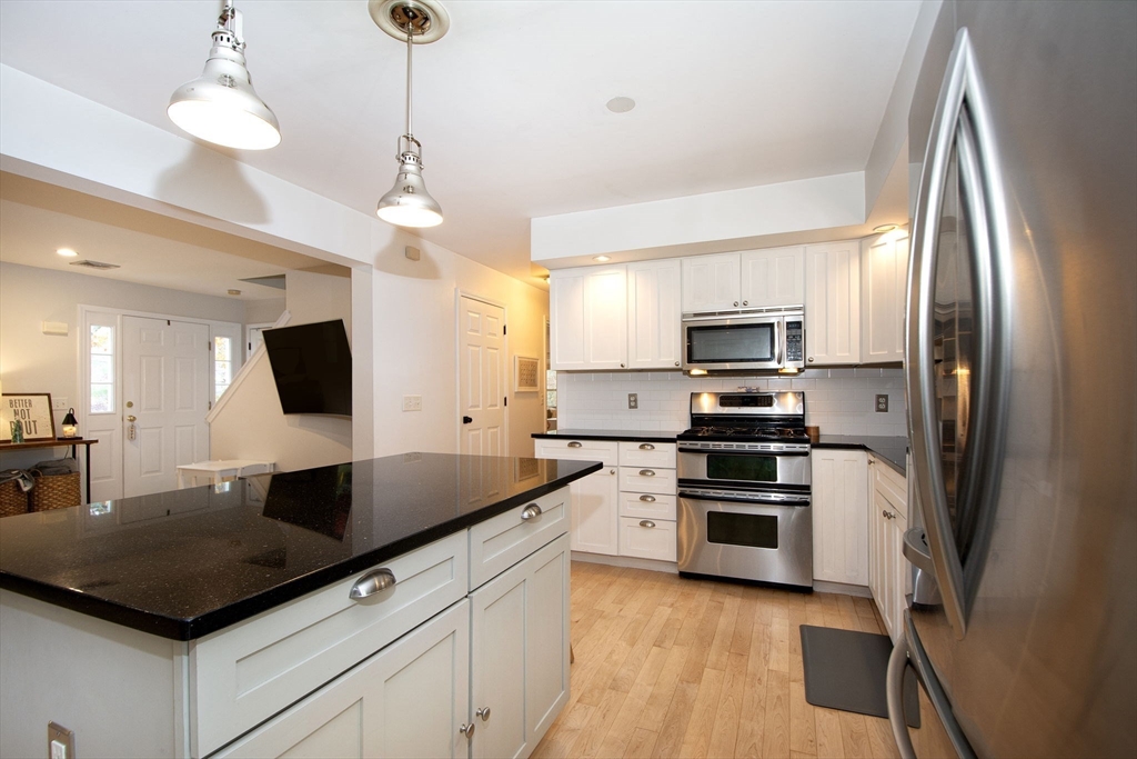 21 Union Street Marshfield, MA 02050 - Photo 9 of 31 a kitchen with stainless steel appliances granite countertop a sink refrigerator and microwave