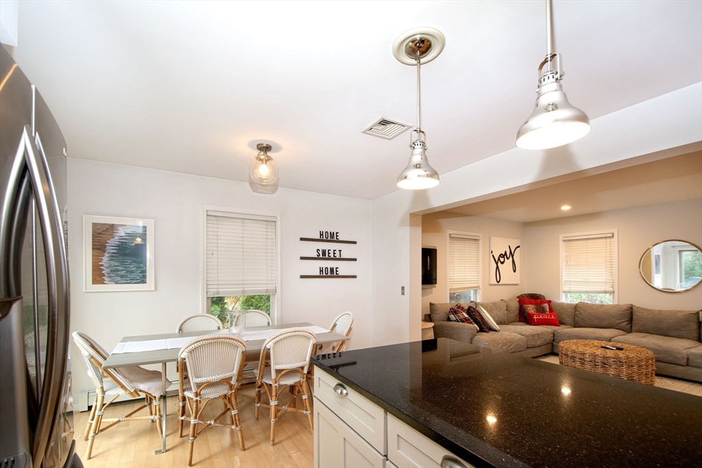 21 Union Street Marshfield, MA 02050 - Photo 10 of 31 a view of a dining room and livingroom with furniture wooden floor a chandelier