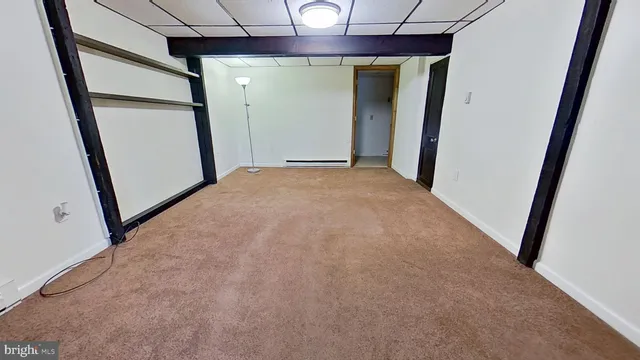 an empty room with wooden floor and entrance