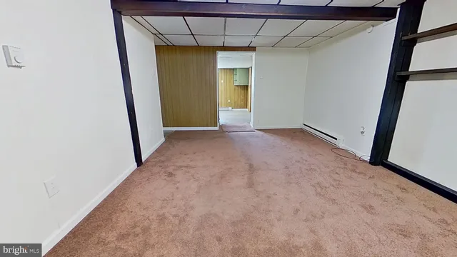 a view of room with window and a door