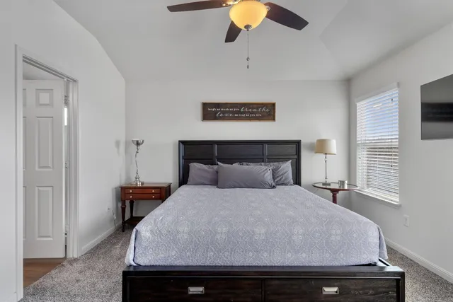 a bedroom with a bed and a chandelier