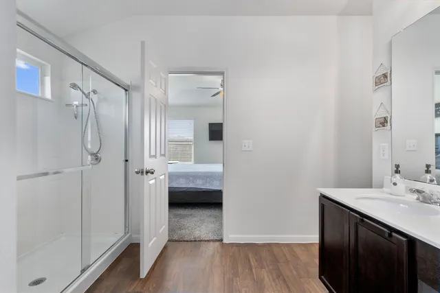 a bathroom with a double vanity sink and mirror