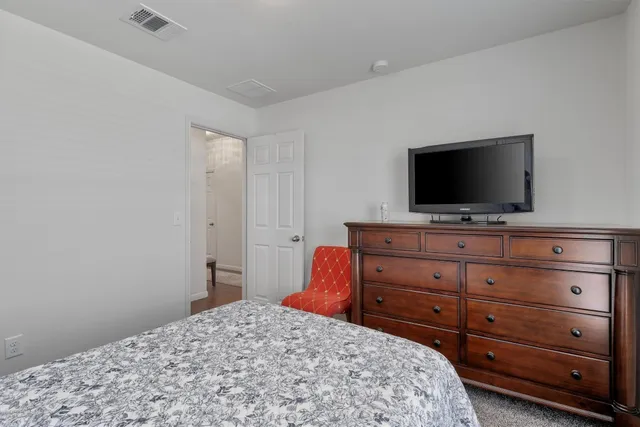 a bedroom with a bed and a flat screen tv