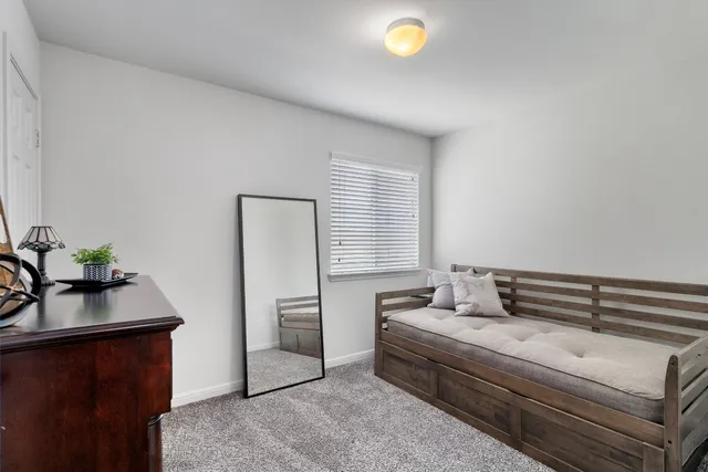 a bedroom with furniture and a window