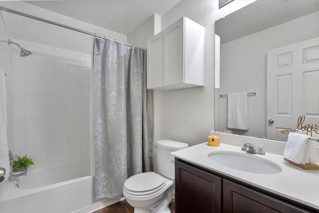 a bathroom with a sink toilet and shower