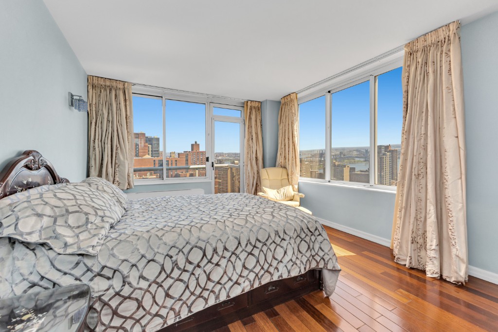 200 East 89th Street, Unit 37D Manhattan, NY 10128 - Photo 12 of 35 a bedroom with a large bed and a window