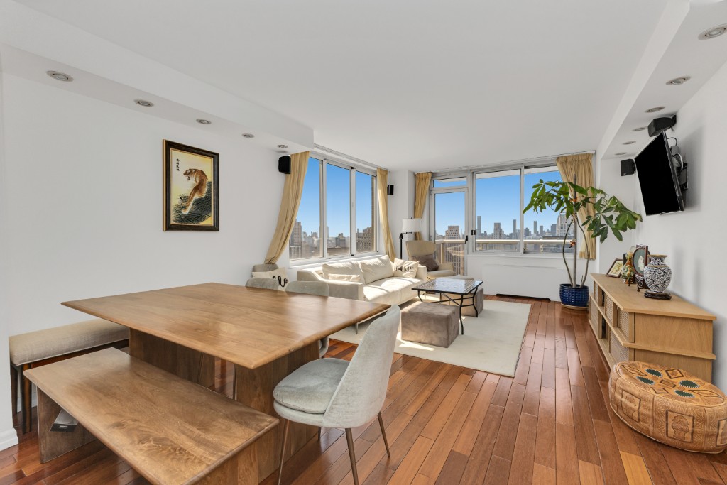 200 East 89th Street, Unit 37D Manhattan, NY 10128 - Photo 9 of 35 a living room with furniture and a flat screen tv