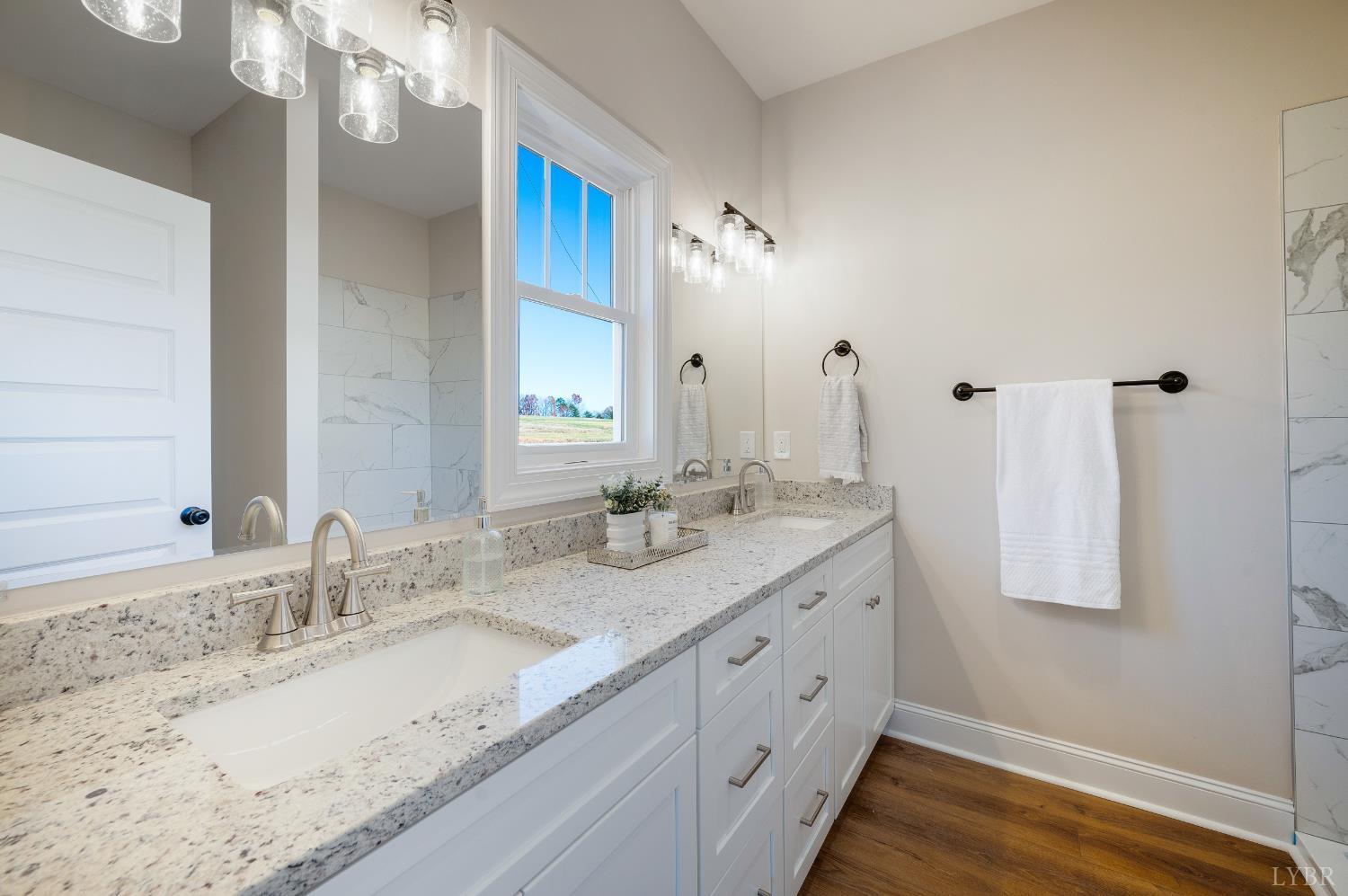 10528 Leesville Road Lynch Station, VA 24571 - Photo 21 of 58 a bathroom with double vanity and a mirror