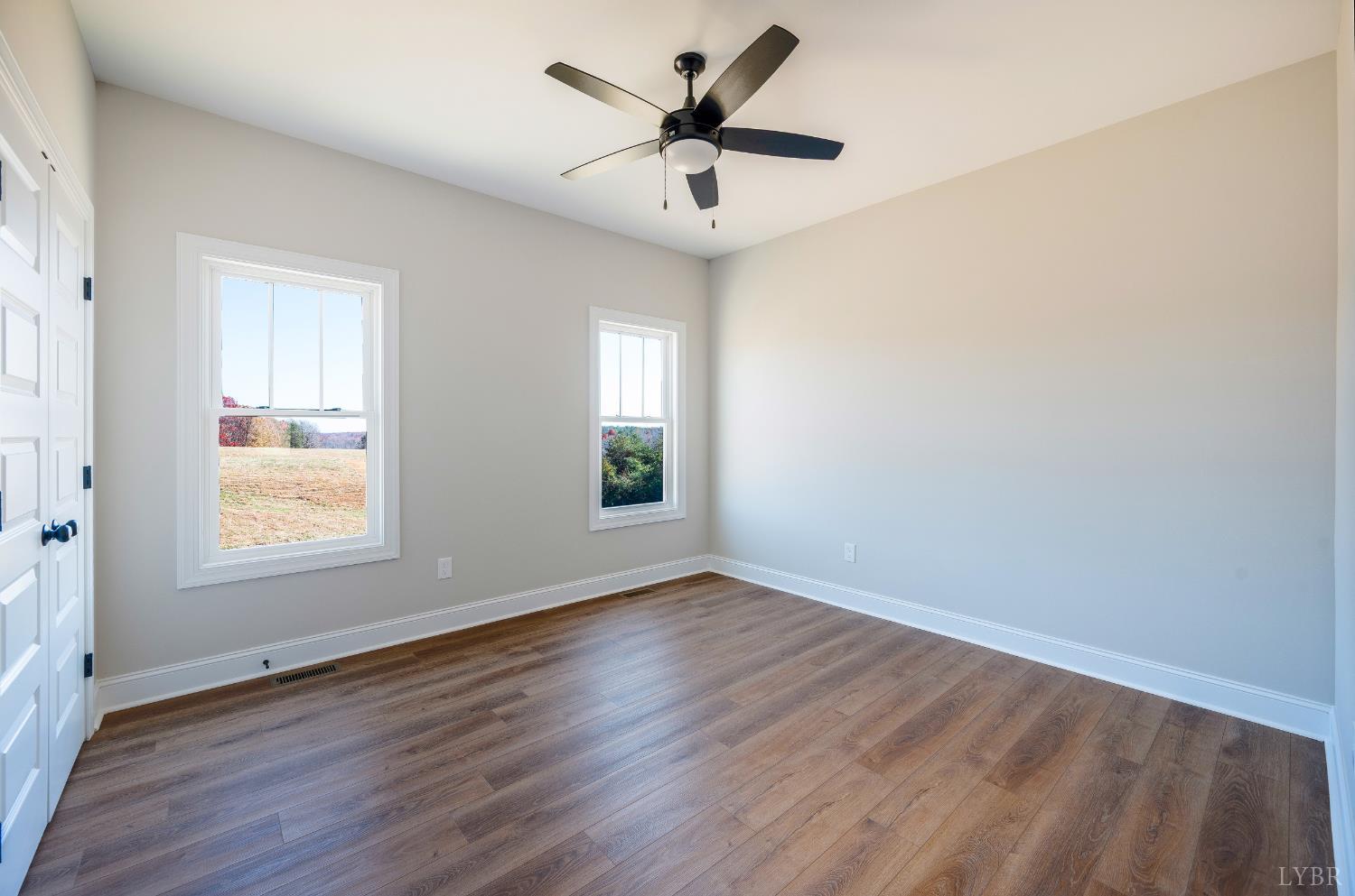 10528 Leesville Road Lynch Station, VA 24571 - Photo 27 of 58 an empty room with wooden floor and windows