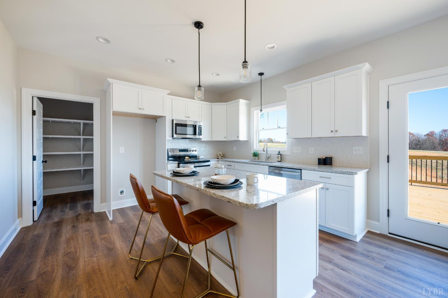 10528 Leesville Road Lynch Station, VA 24571 - Photo 10 of 58 a kitchen with a dining table chairs refrigerator and cabinets