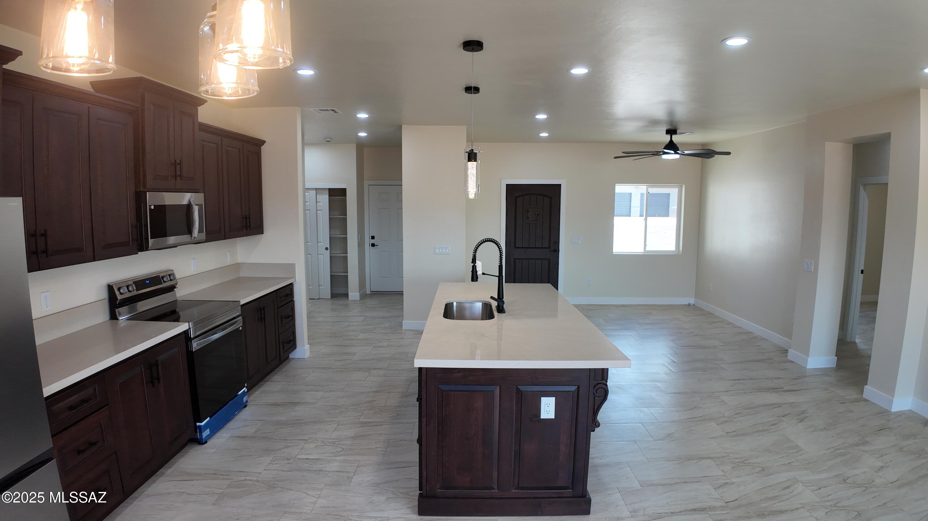 1786 Palestina Corte Rio Rico, AZ 85648 - Photo 14 of 28 a large kitchen with stainless steel appliances a large counter top