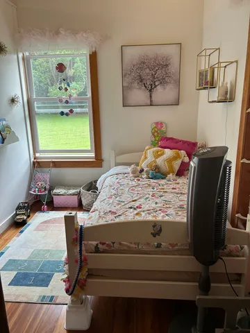 a bedroom with a bed and window