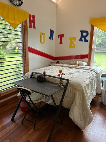 a bedroom with a bed and a window