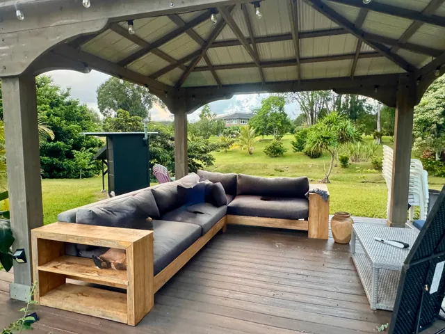 a view of a patio with couches under an umbrella