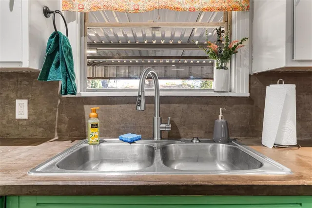 a kitchen with lots of counter space cabinets and a sink