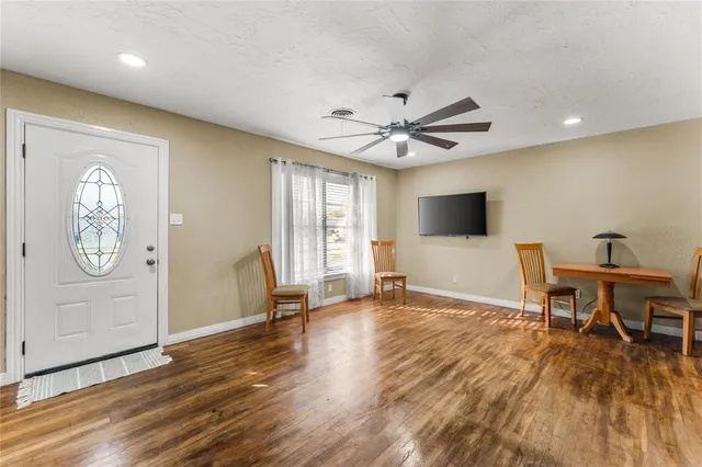 a view of a hallway with wooden floor and a chandelier