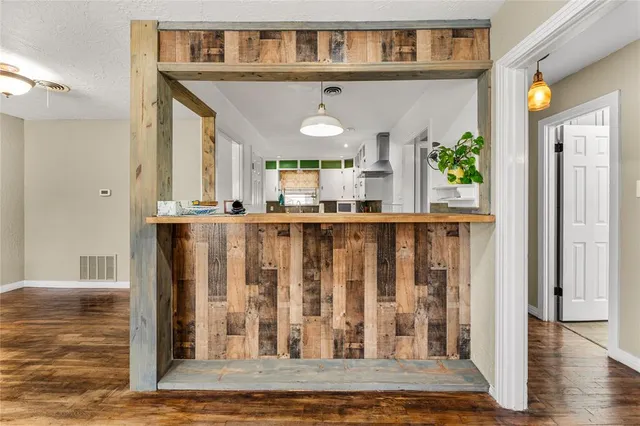 a view of a livingroom with a ceiling fan window and wooden floor