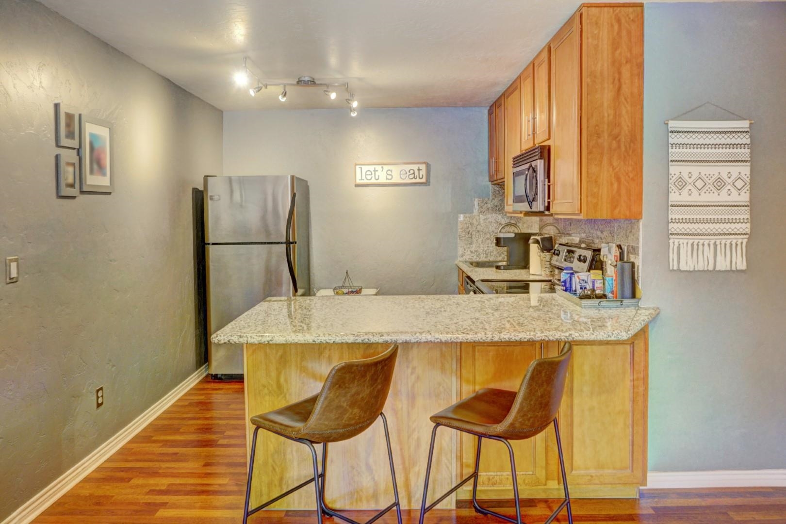 948 Northern Way, Unit 4 Grand Junction, CO 81506 - Photo 5 of 15 a kitchen with cabinets and refrigerator