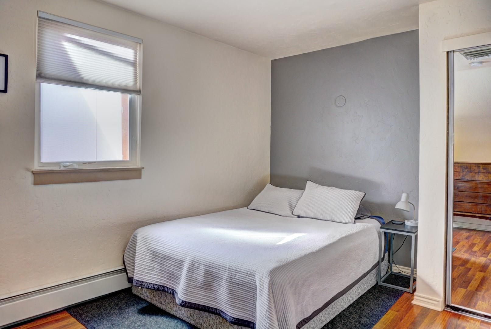 948 Northern Way, Unit 4 Grand Junction, CO 81506 - Photo 9 of 15 a bedroom with a bed and a mirror