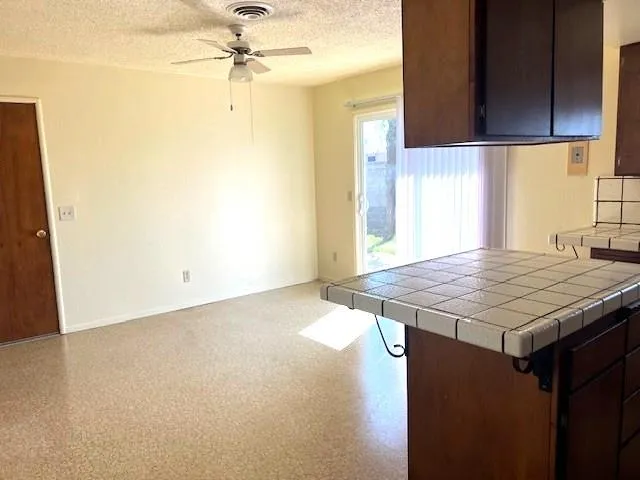 a kitchen with a table a sink and cabinets