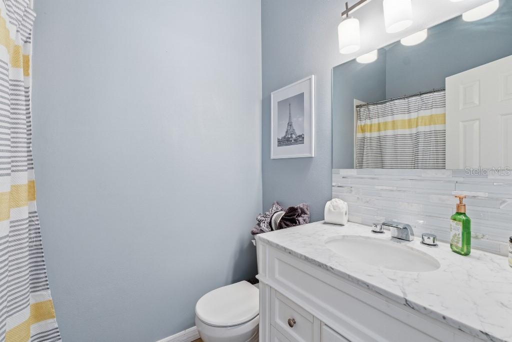 25130 Ensley Road Sorrento, FL 32776 - Photo 12 of 15 a bathroom with a granite countertop toilet sink and mirror