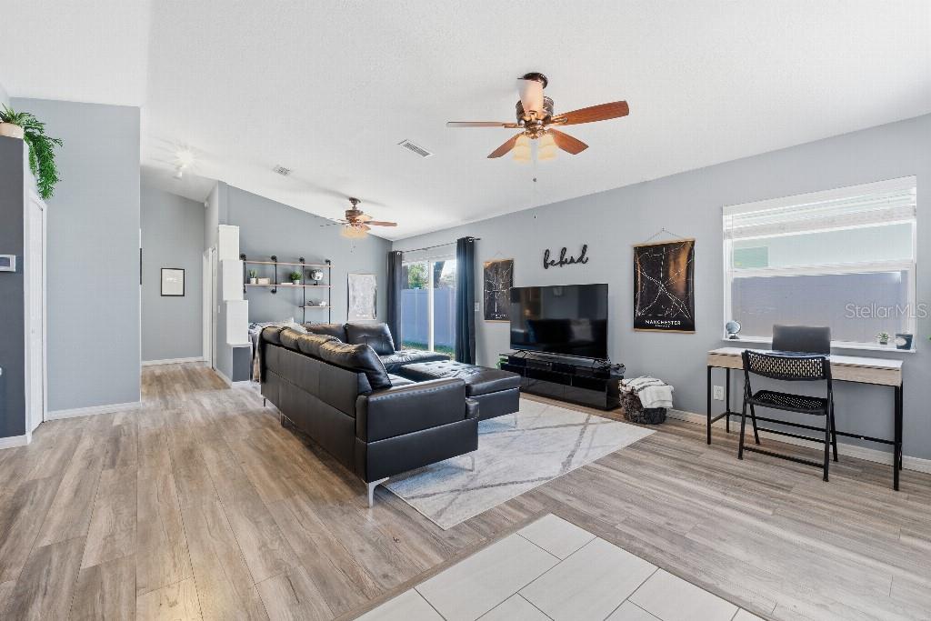 25130 Ensley Road Sorrento, FL 32776 - Photo 3 of 15 a living room with furniture and a flat screen tv