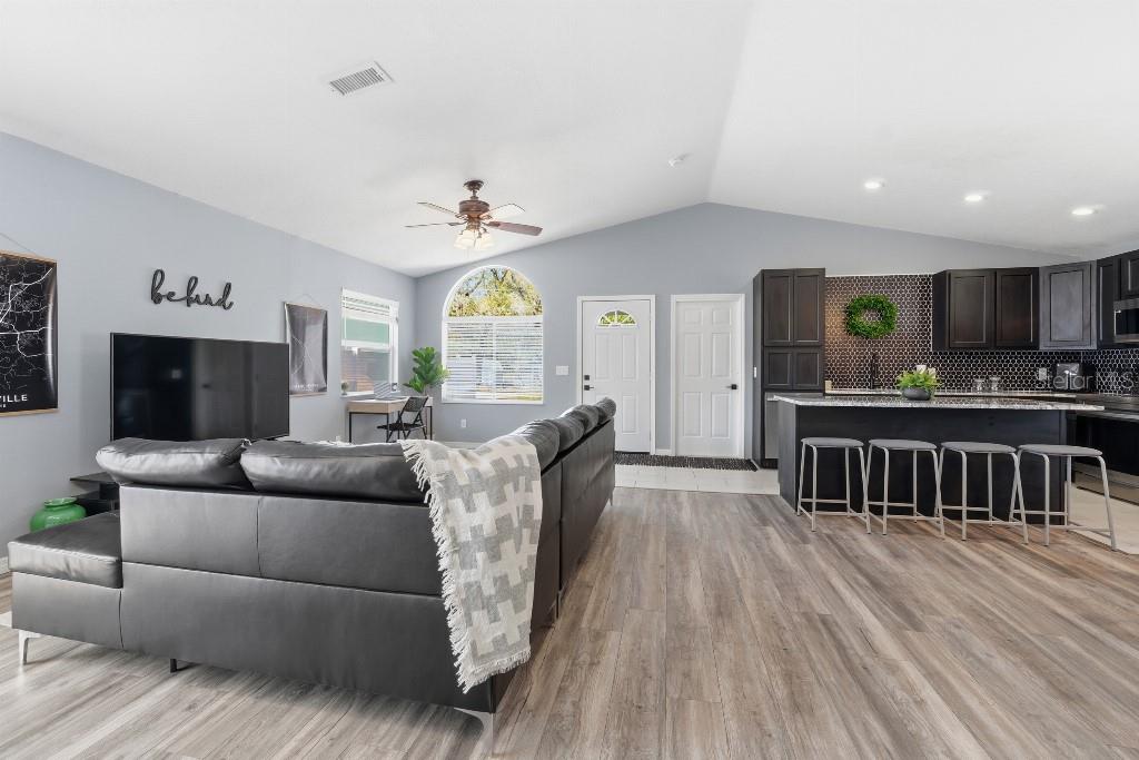 25130 Ensley Road Sorrento, FL 32776 - Photo 5 of 15 a living room with furniture and a flat screen tv
