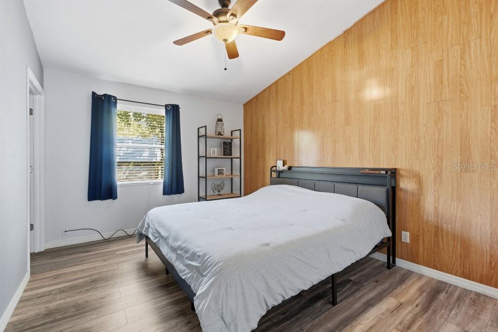 25130 Ensley Road Sorrento, FL 32776 - Photo 8 of 15 a bedroom with a large bed and a chandelier