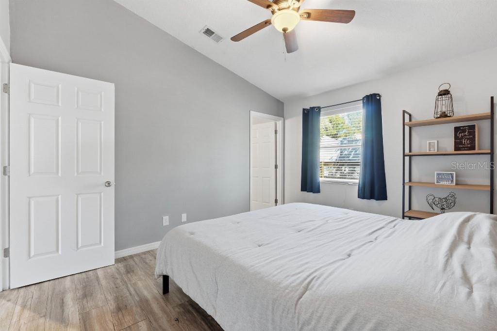 25130 Ensley Road Sorrento, FL 32776 - Photo 9 of 15 a bedroom with a bed and a chandelier