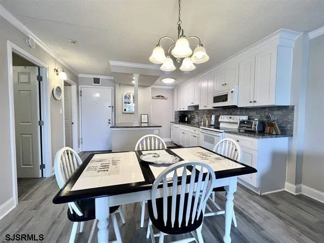 a kitchen with stainless steel appliances granite countertop white cabinets sink and dishwasher