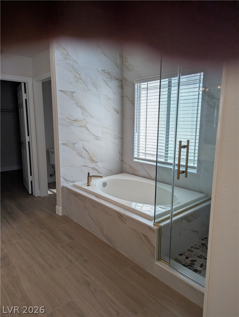 327 Perry Ellis Drive Henderson, NV 89014 - Photo 40 of 54 This tranquil bathroom features a soaking tub and a separate shower, creating a serene personal retreat.