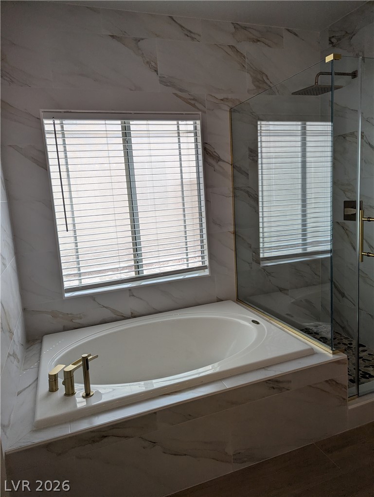 327 Perry Ellis Drive Henderson, NV 89014 - Photo 41 of 54 Relax in the generously sized soaking tub or invigorate in the modern shower with a rainfall showerhead.