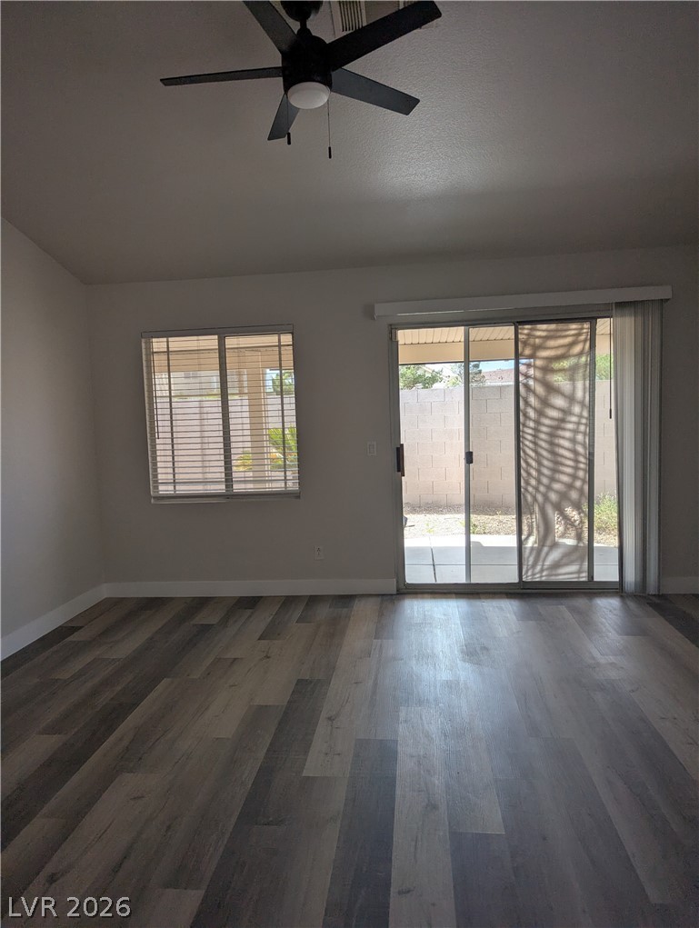327 Perry Ellis Drive Henderson, NV 89014 - Photo 44 of 54 Bright room with wood flooring and access to a private yard through sliding glass doors.