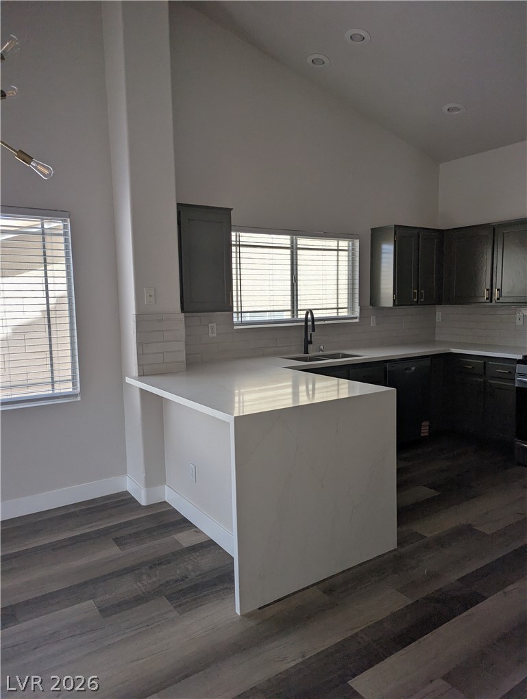 327 Perry Ellis Drive Henderson, NV 89014 - Photo 46 of 54 This modern kitchen features a sleek island and ample cabinet space, perfect for culinary endeavors.